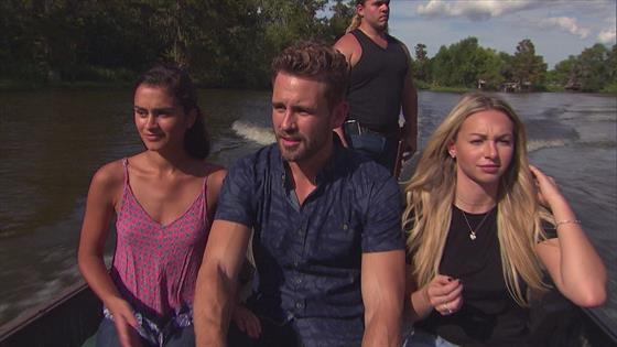 Taylor, Nick and Corrine sit in a boat, riding through the bayou.