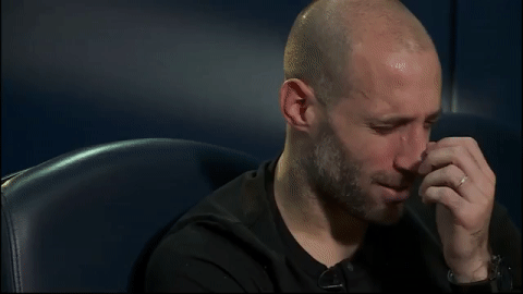 A close up of a man's face as he gags