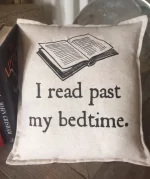 A pillow with a book picture that says I read past my bedtime