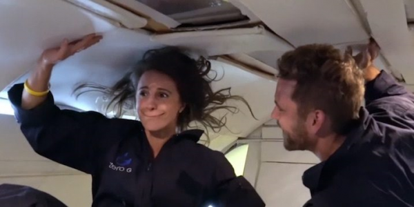 Nick and Vanessa float weightless in a zero g plane.