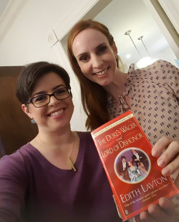 Me in a purple v-neck and Faith who is taller and has really lovely red hair holding a copy of The Dukes Wager by Edith Layton