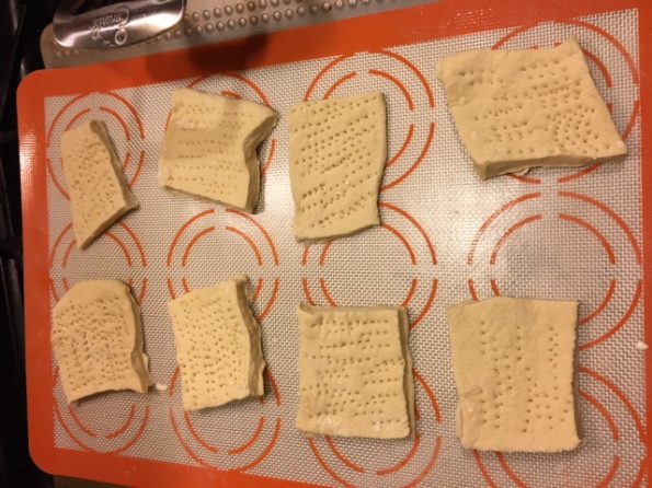 Squares of hard tack stabbed with a fork 