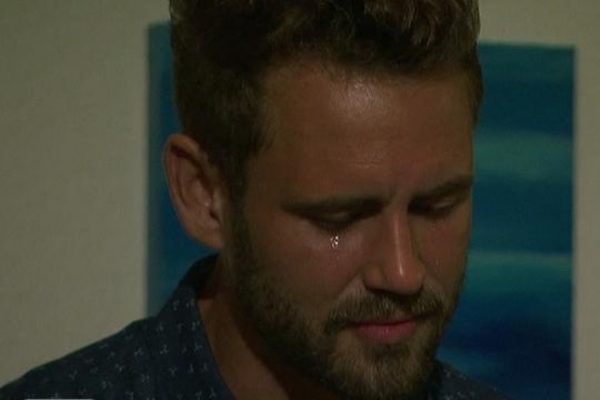 Nick Viall looks down while a tear rolls down his cheek.