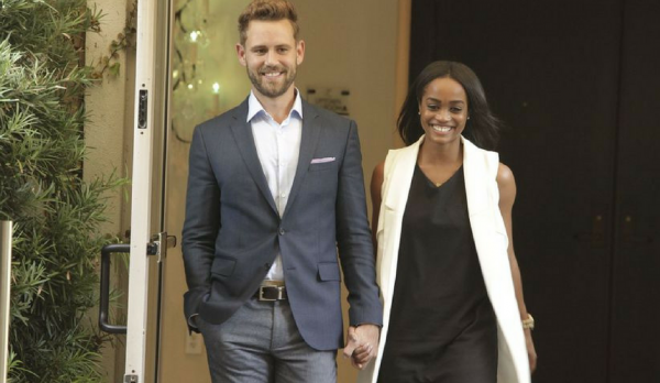 Nick and Rachel hold hands.