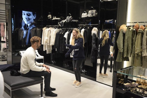 Nick watches Corinne shop for clothes.