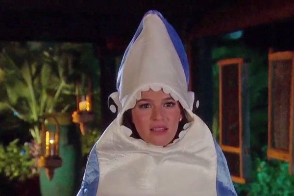 Alexis wears a shark costume.