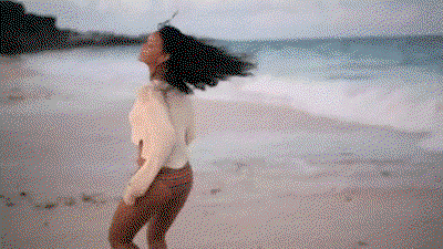 Rihanna dances on a beach.