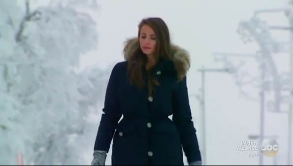Vanessa walks through a frozen woods.