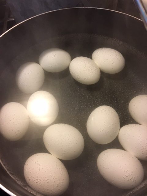 Eggs boiling in the pot.