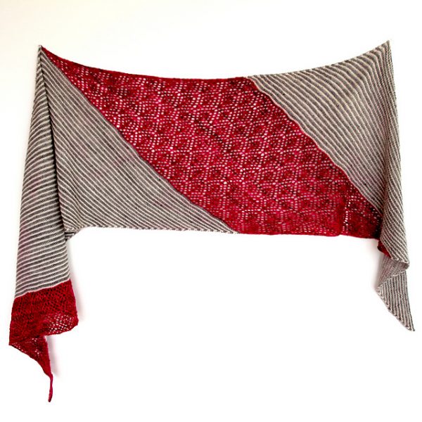 Lilli Pilli is a rectangular shawl that alternates diagonal striping and lace work. The sample has red lace work sections alternated with grey and cream stripes.