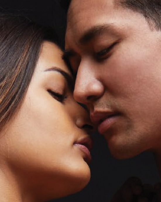 A close up of the models' faces, nearly kissing and scant millimeters apart
