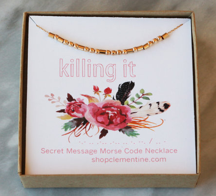 Gold necklace that spells out KILLING IT in morse code 
