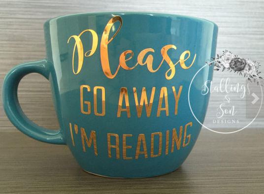 Medium blue mammoth mug with Please go away I'm reading in gold on the site 