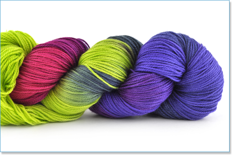 A skein of yarn in vibrant green, purple and pink