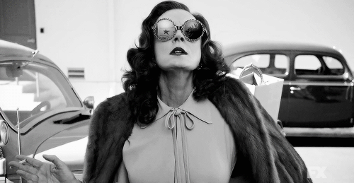 Jessica Lange in a black and white image smoking another cigarette