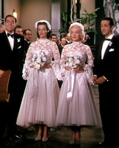 Lorelei and Dorothy's matching tea-length, lace wedding dresses.
