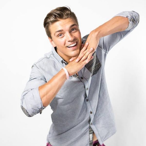 Dean is posing with his hands under his chin, arms extending like wings.