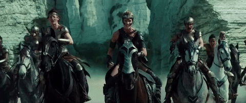 The Amazons from Wonder Woman charge the screen on horseback, weapons drawn