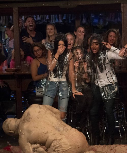 Kenny tackles another dude while Rachel and the girls cheer him on.