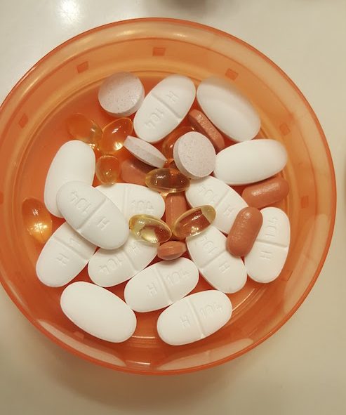 Close up of orange GoTub with medication inside