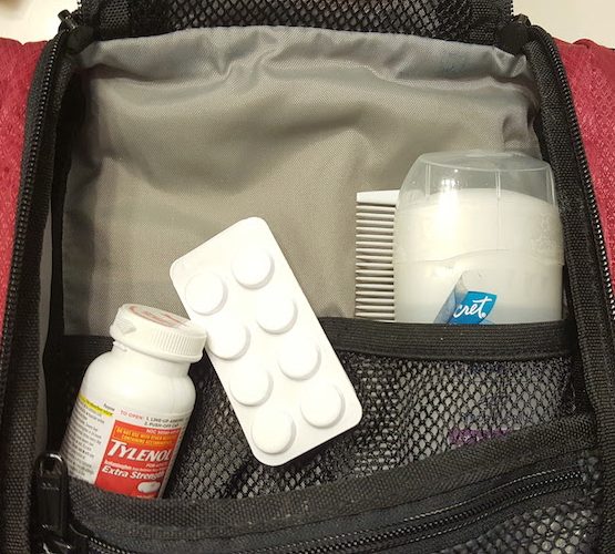 Close up of Tylenol, deoderant, and comb