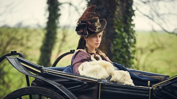 Elizabeth, in fancy carriage and wearing a fancy hat, holding her fancy baby, glaring at D.