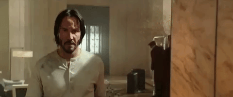 A sweaty, angry John Wick strides down a hallway. Probably to kill someone.