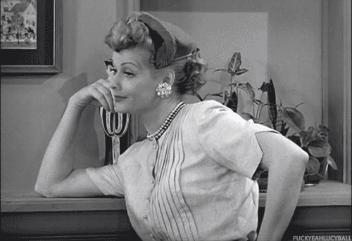 Lucille Ball rolling her eyes with her head resting on one finger 