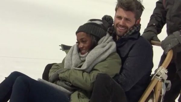 Rachel and Peter snuggle up in the dog sled.