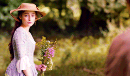 Morwenna holding her flowers, walking back to Drake