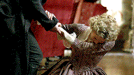Caro, collapsed on the ground, holding a hand to her chest, like her heart has finally started beating again.