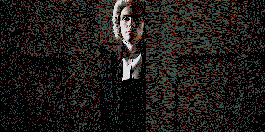 George, flanked by two other magistrates, power-walking through double doors and into the court room.