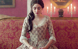 Morwenna, sitting on the red and gold couch, staring down at her hands as Whitworth prattles on.