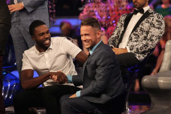 DeMario shakes Lee's hand. There's a super unfortunate black and white dinner jacket on some dude in the background.