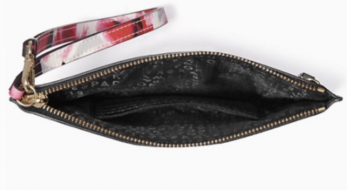 Interior image of the Kate Spade wristlet with black patterned lining and inside pocket
