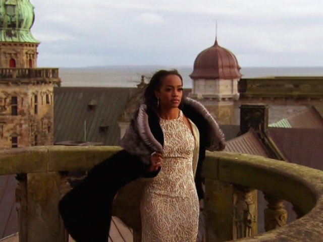 Rachel wears an evening gown and a glorious cape like some kind of medieval princess.