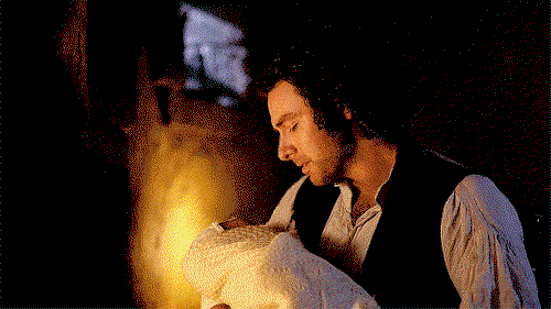 Ross, cuddling baby Clowance by the fire