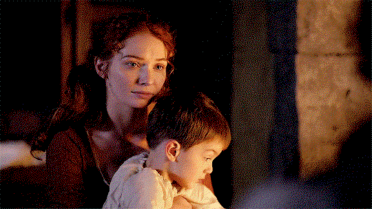 Demelza, on the other side of the fire, holding Jeremy