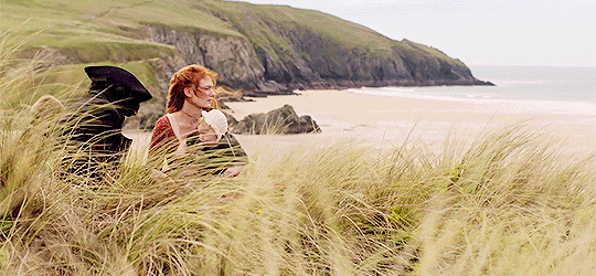 The Family Poldark, all four of them, sitting above the sea