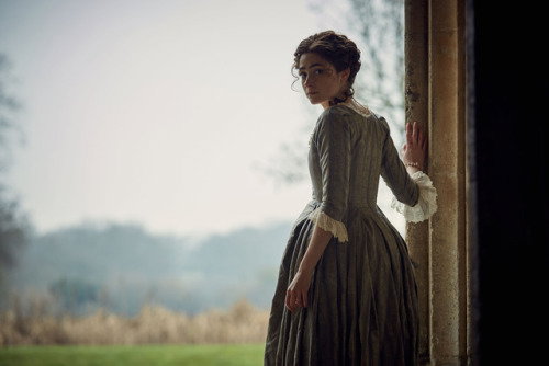 Morwenna, standing in the doorway and looking back in.