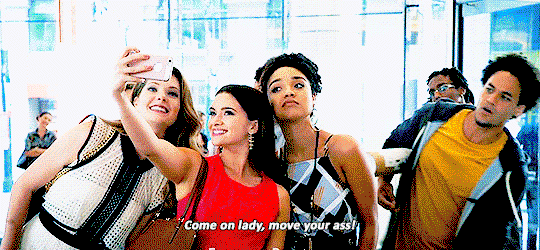 Sutton, Jane, and Kat taking a selfie in the lobby of their building, and some asshole behind them snapping Come on lady, move your ass!