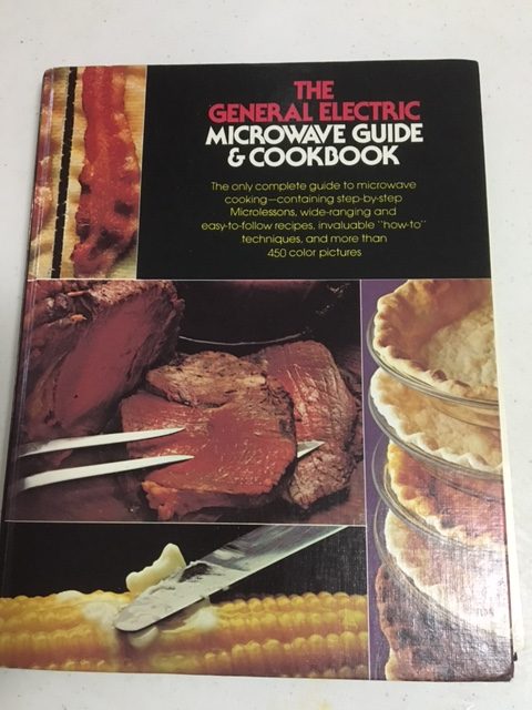 Book cover. IT'S SO SEVENTIES YOU GUYS. The General Electric Microwave Guide and cookbook - the only complete guide to microwave cooking containing step by step microlessons and more than 450 color pictures!