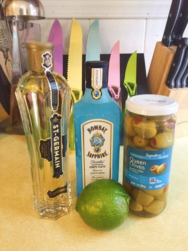 Ingredients for the Divinian - gin, st germain, olives and lime