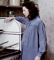 Claire, super pregnant and super annoyed at her stove.