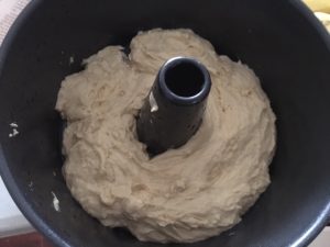 Beaten down dough, in the bundt cake pan.