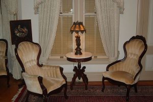 sitting room with 2 chairs, table, and lamp