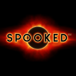 Spooked in black letters over a blacked out sun, almost like an eclipse