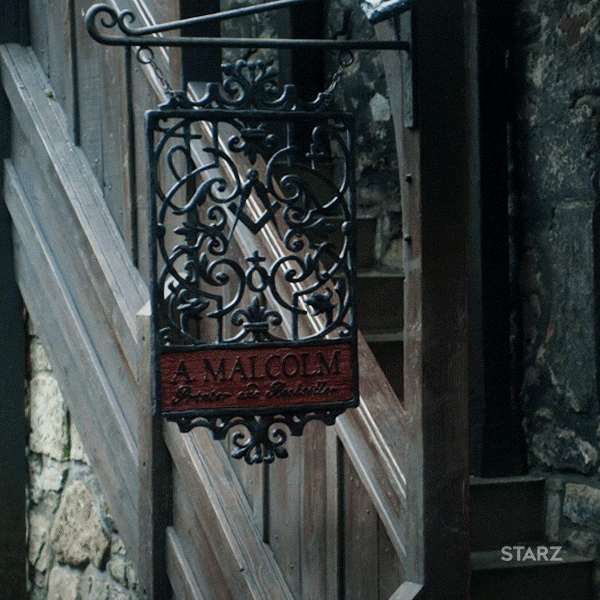 Claire looks at the sign for the print shop