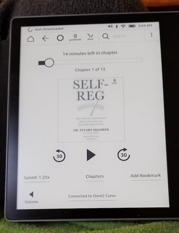 Kindle Oasis playing Self Reg, an nonfiction audiobook