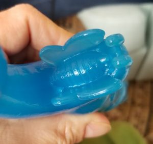 blue rubber butterfly clitoral stimulator on a vibrator
